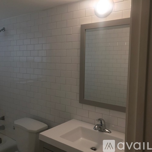 A white toilet sits next to a sink in a bathroom.