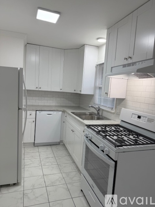 A kitchen area with a refrigerator, microwave, and oven.
