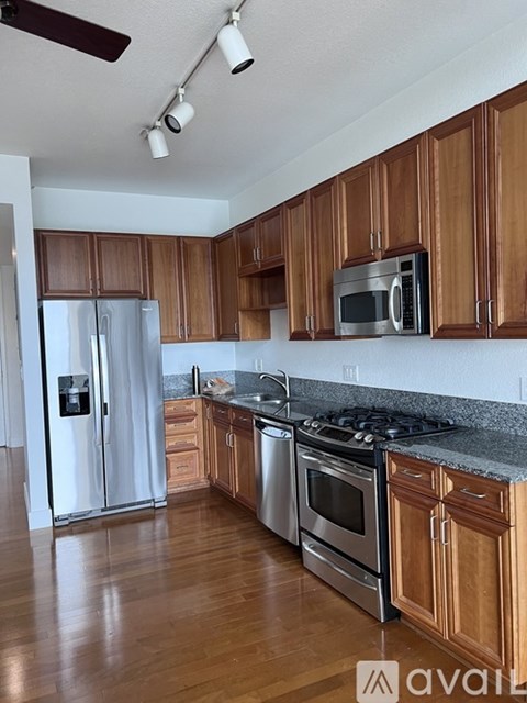 A kitchen with wooden cabinets and stainless steel appliances.