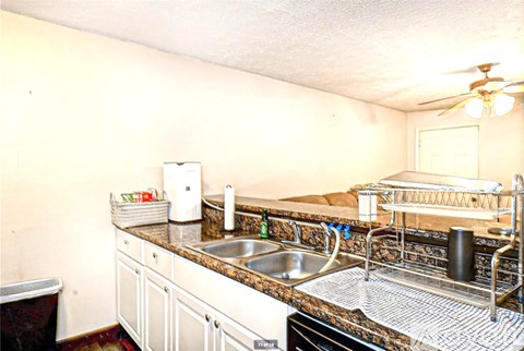 A kitchen with a sink and a counter.
