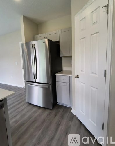 A kitchen with a stainless steel refrigerator and dishwasher.