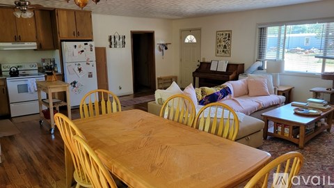 A kitchen with a table and chairs in the foreground.