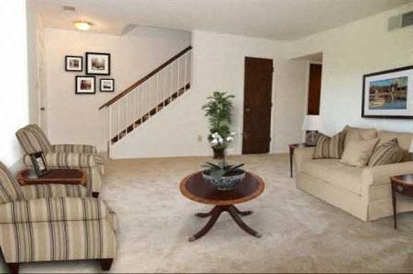 a living room with two chairs and a table