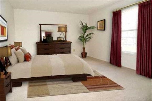 a bedroom with a bed and a potted plant