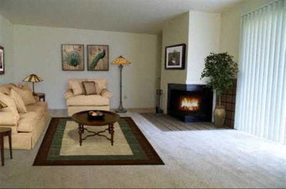 a living room with a couch and a fireplace