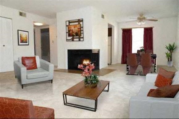 a living room with couches and chairs and a fireplace