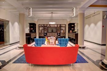 Lounge And Seating Areas Including A Media Wall In The Mail Room at Somerset Place Apartments, Chicago, IL