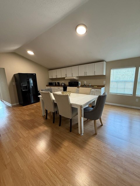 A kitchen with a table and chairs in the middle of the room.