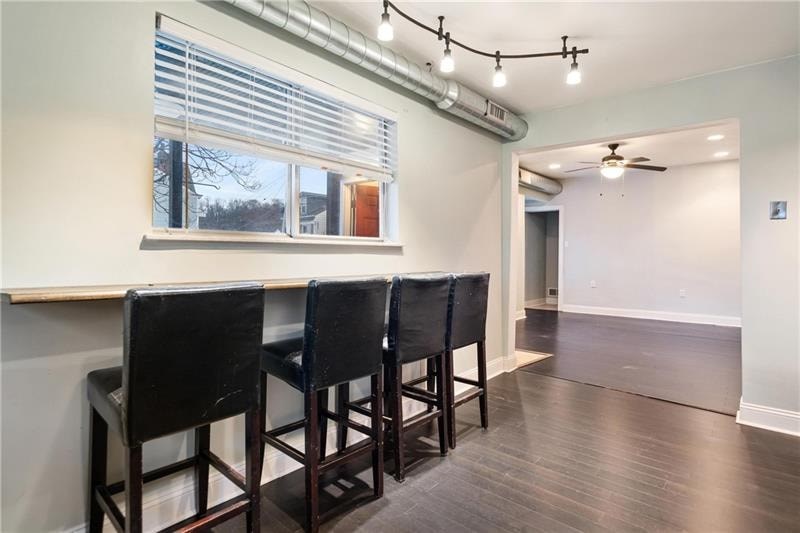 A room with a long table and chairs.