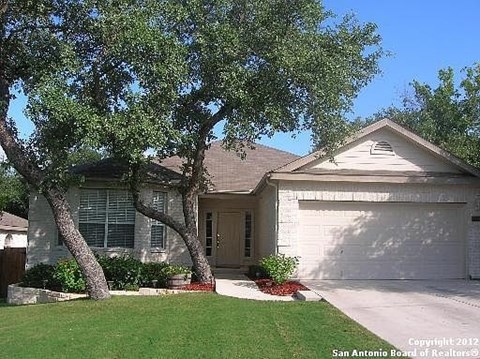 A house with a tree in front of it.