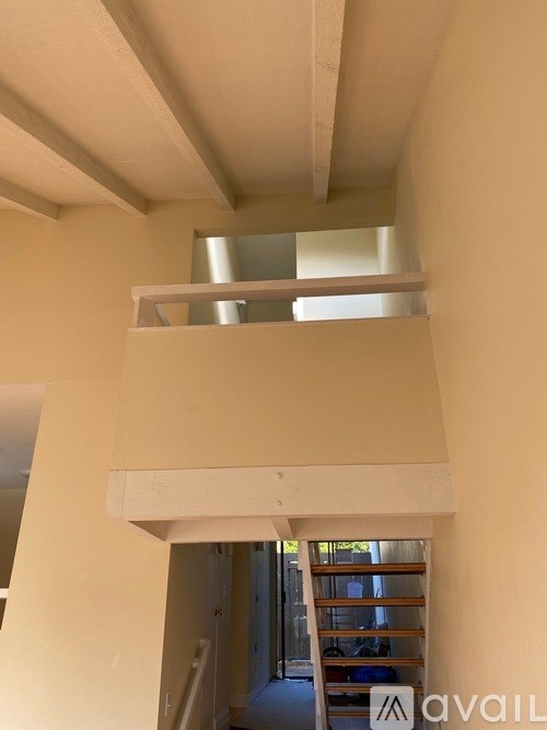 A white staircase with a skylight above it.