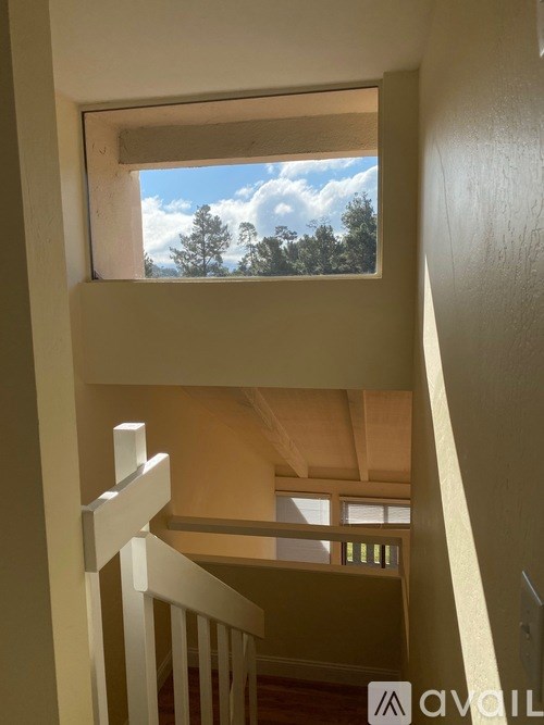 A view of the sky through a window in a room.