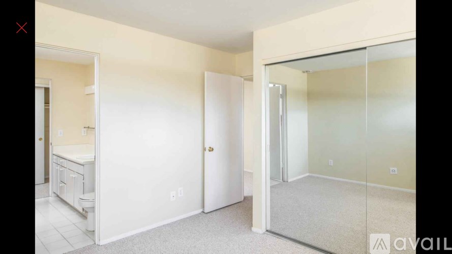 A room with a white door and a glass wall.