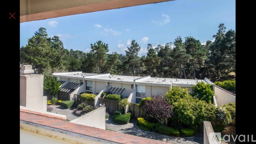 A view of a residential area with houses and trees.
