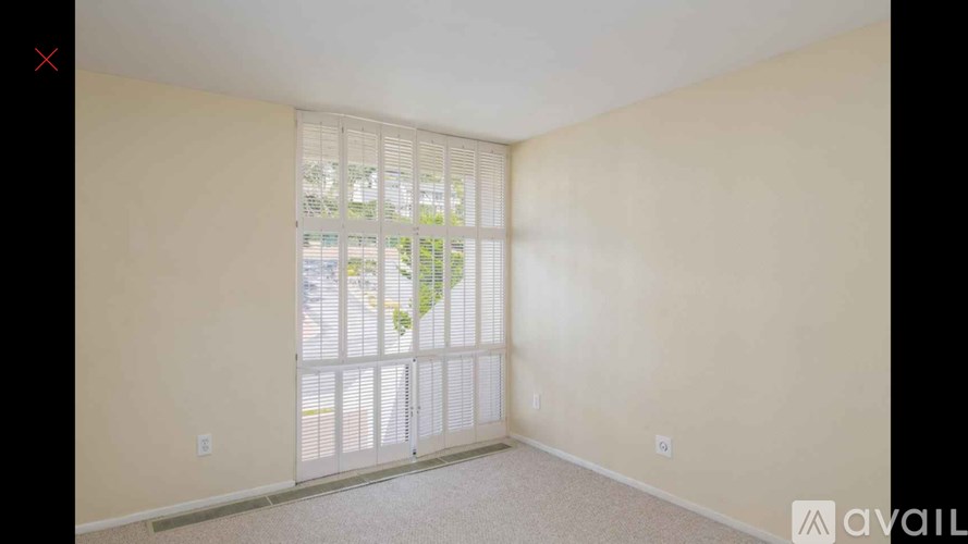 A room with a sliding door leading to a balcony.