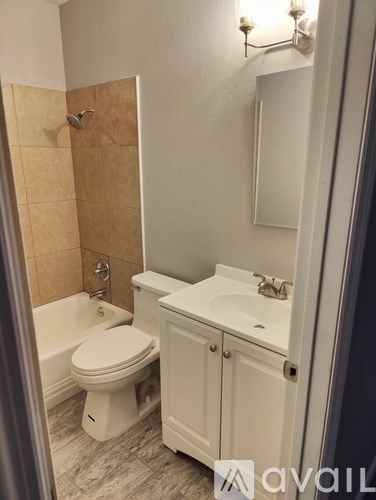 A white toilet sits next to a sink in a bathroom.