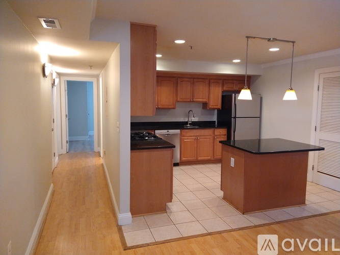 A kitchen with wooden cabinets and a black countertop.