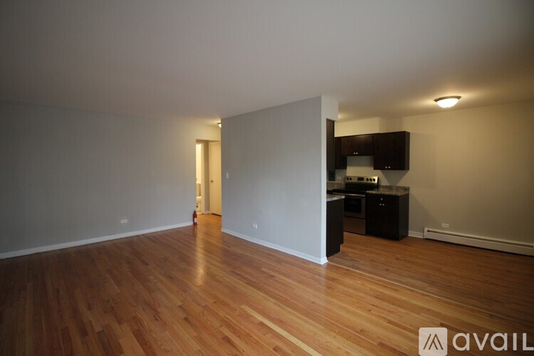 A room with wooden floors and a cabinet in the corner.