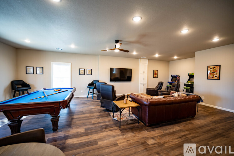 A room with a pool table and a couch.