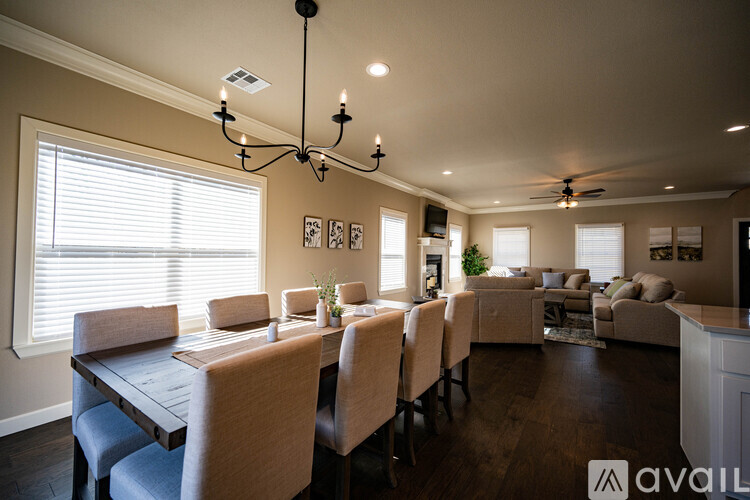 A dining room with a long table and chairs.