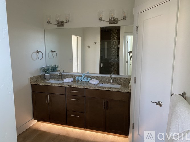 A bathroom with a vanity and a mirror above it.