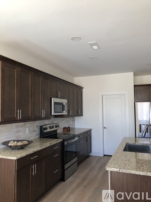 A kitchen with brown cabinets and a white countertop.
