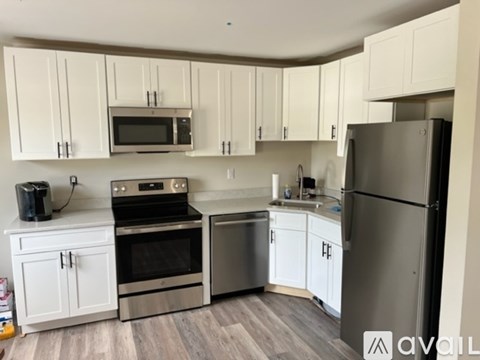 A kitchen with white cabinets and stainless steel appliances.