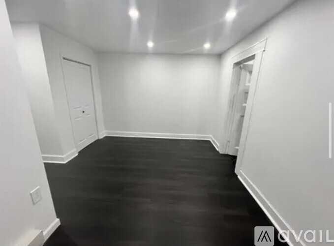 A room with black flooring and white walls.