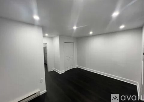 A room with a black floor and white walls.