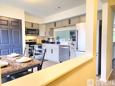A kitchen with a table set for two.