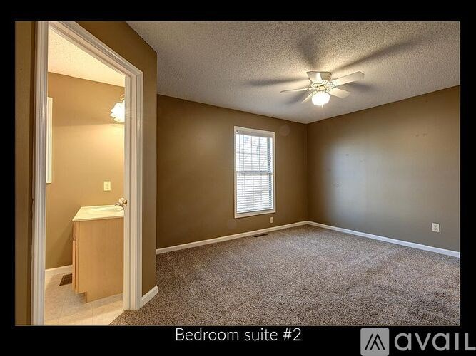 Bedroom suite #2 with carpeted floor and ceiling fan.