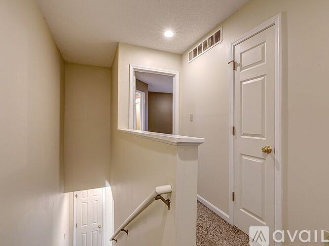 A small room with a white door and a window.