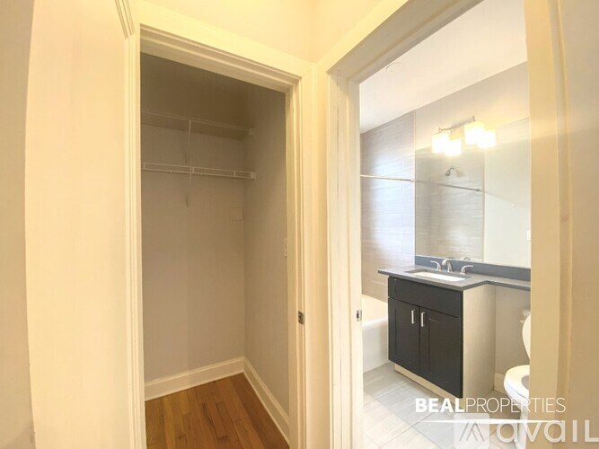 A white doorway opens to a bathroom with a sink and a toilet.