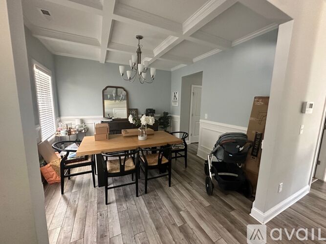 A dining room with a wooden table and chairs.