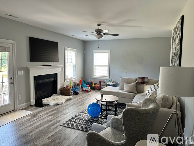 A living room with a fireplace, a television, and a couch.
