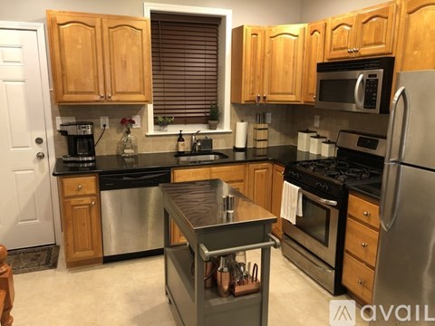 A kitchen with wooden cabinets and stainless steel appliances.