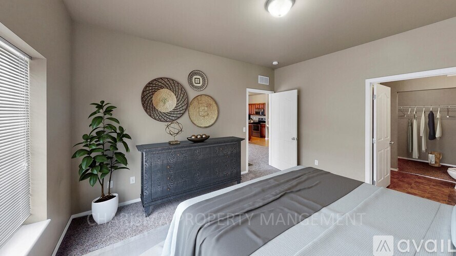 A bedroom with a bed, dresser, and mirror.