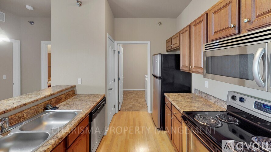 A kitchen with granite countertops and stainless steel appliances.