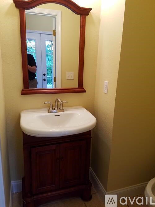 A bathroom with a sink and mirror.
