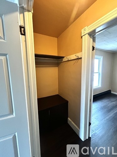 A room with a white door and a black table.