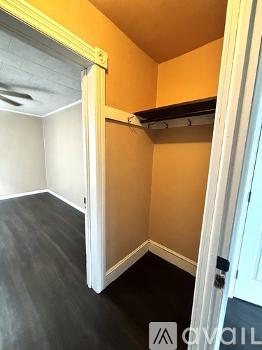 A room with a white door and a black floor.