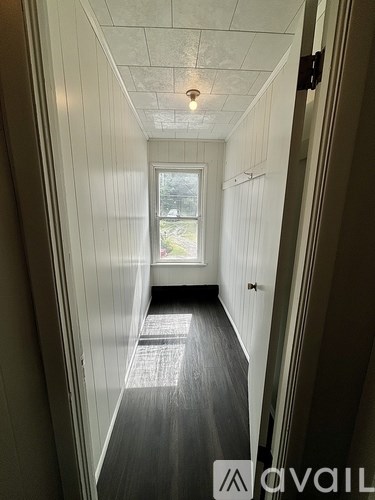 A long hallway with a window at the end.