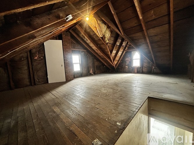A room with wooden floors and a white door.