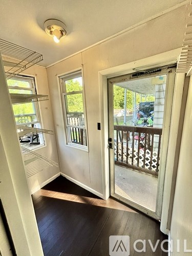 A room with a sliding door leading to a balcony.