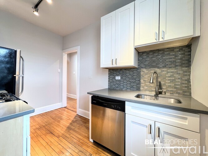 A kitchen with a stove, oven, and microwave.