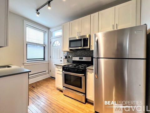 A kitchen with a stove top oven and a dishwasher.