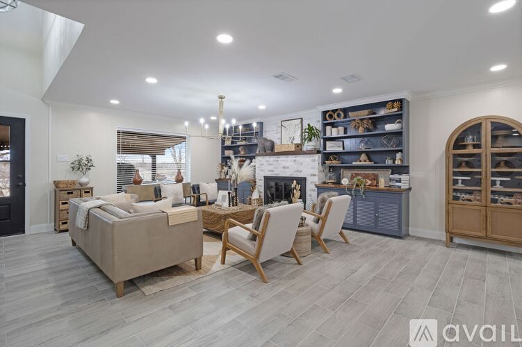 A well-lit, spacious living room with a variety of furniture and decor.