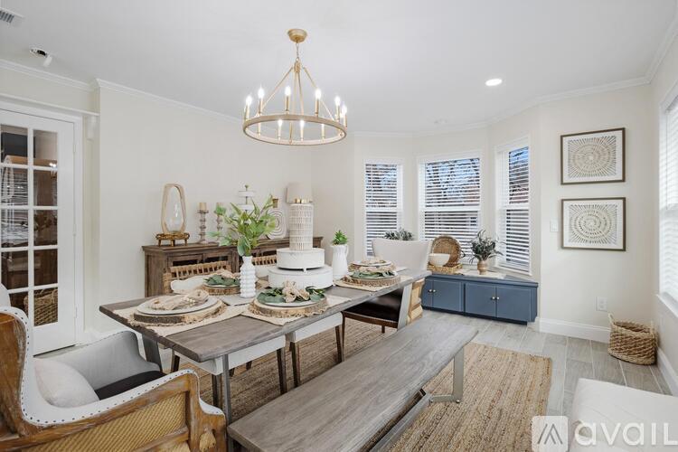 A dining room with a table set for a meal.