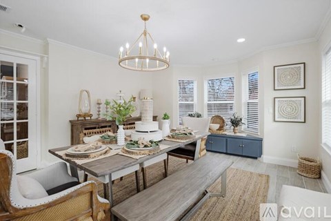 A dining room with a table set for a meal.