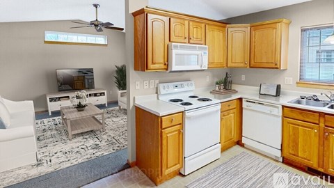 A kitchen with wooden cabinets and white appliances.